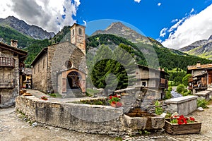 Old church and mountains in small alpine village of Chianale, Italy