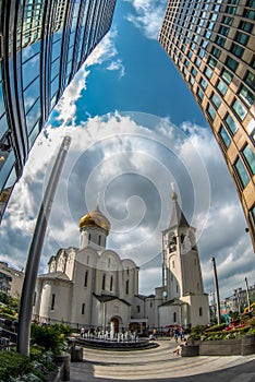 An old church next to a modern business center