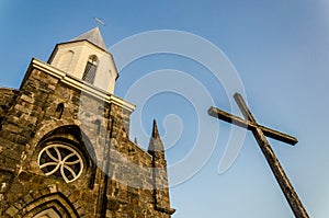 old church, old wooden cross against the sky