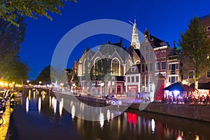 Old Church Oude Kerk and Amsterdam canals at night, Netherlands