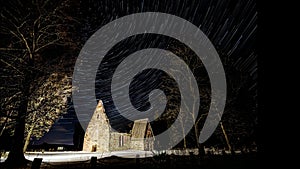 Old church ruins and churchyard star trails time lapse