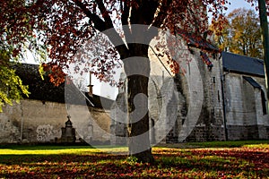 Old church in a small village in North of France during autumn season