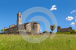Old church under blue sky in Piedmont, Italy.