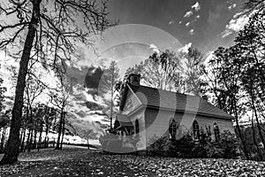 Old Church in woods with dramatic sky - monochrome