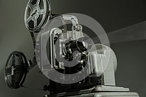 Old cinema projector on a dark background photo