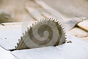 Old Circular saw. Carpentry. Background of wood and ax