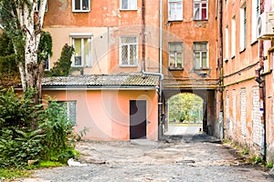 Old city courtyard with an entrance arch