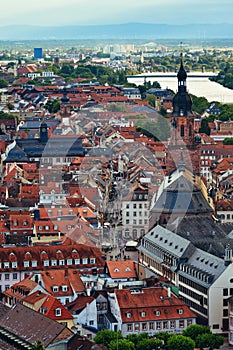 The Old City of Heidelberg with the pedestrian area and the Church of the Holy Spirit. River Neckar in the background. Germany