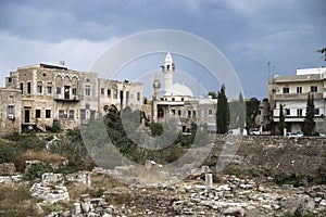 Old city with mosque and ruins with dramatic cloudscape in Tyre, Sour, Lebanon