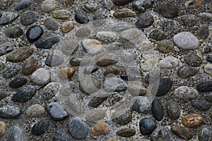 Old city pavement made of pebbles. Milan, Northern Italy, Europe