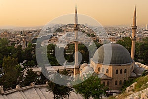 Old city of Sanliurfa, Turkey. Mevlidi Halil Cami mosque and minarets at dusk. photo