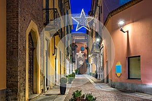 Old city street and Christmas illumination in Alba, Italy.
