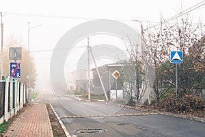 Old city street in fog, autumn weather