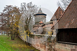 Old city wall with watch towers surrounding medieval city.