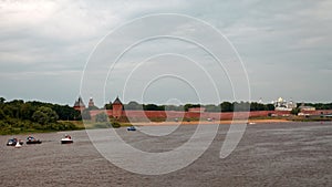 Old city walls and towers of Veliky Novgorod, Russia. Beach on the Volkhov River