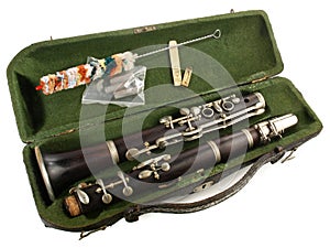 Old clarinet in a case with brush isolated on white Background