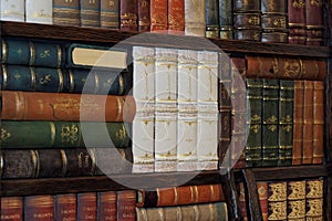 Old classic books on bookshelf photo