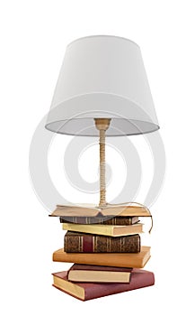Old classic books stacked with innovative lamp