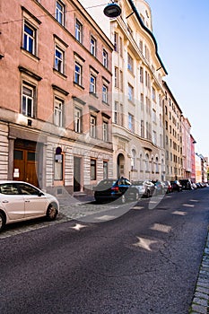 Old classic buildings on the street in Vienna. Architectural Classical Baroque Facades of beige and pale pink houses with stucco