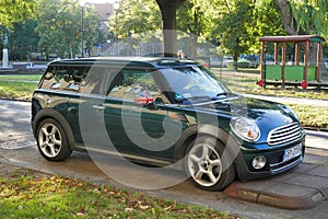 Old classic dark greeny Mini Cooper second version parked