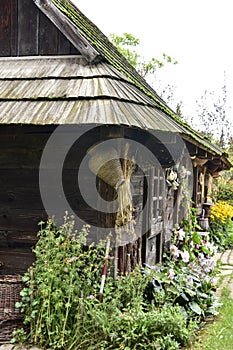 An old classic European wooden house complete with a yard, a classic country garden and a shed