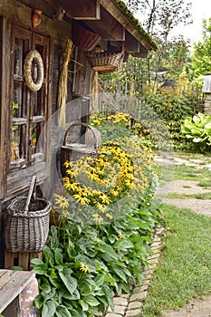 An old classic European wooden house complete with a yard, a classic country garden and a shed