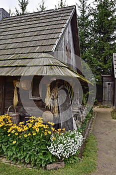 An old classic European wooden house complete with a yard, a classic country garden and a shed