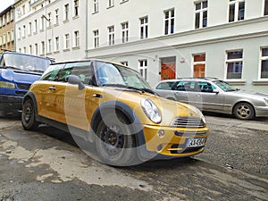 Old gold metallic Morris Mini Cooper private car parked