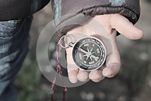Old classic navigation compass in childs hand