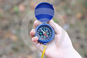 Old classic navigation compass in childs hand