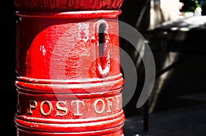 Old Classic red mail post box in close up.