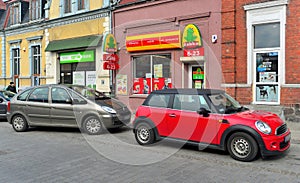 Old classic small car Mini Cooper 2nd generation and Citroen Xsara Picasso parked