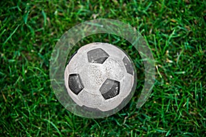 Old and classic Soccer ball or football ball on green field