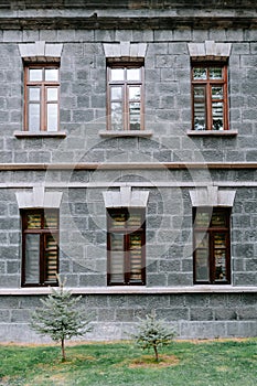 An old classic stone house with windows. Calssic stone walls and windows textures.