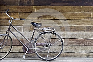 Old classic style bicycle park on old rough texture wood stripe