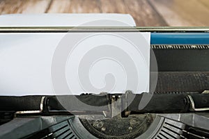 An old classic typewriter on wooden desk. Copy space. For text purpose.