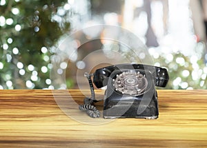 Old classic vintage dial telephone on wooden table