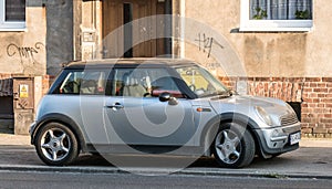 Old classic silver grey Mini Cooper parked