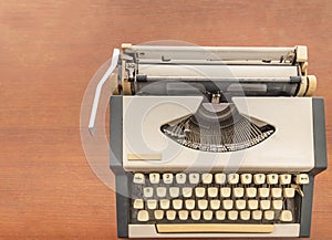 Old classic vintage typewriter on wooden desk