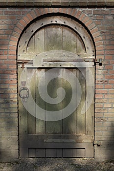 Old classic wooden door in a stone wall