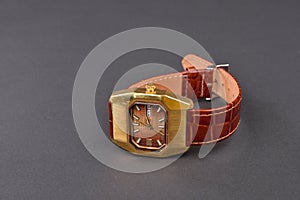 Old classic wristwatch for woman with brown strap on black