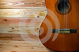 Old classical guitar on wooden background