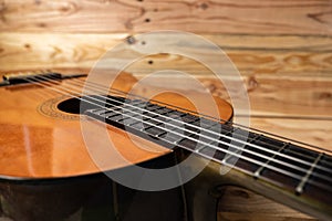 Old classical guitar on wooden background