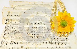 Old classical music scores with pearls and flower photo