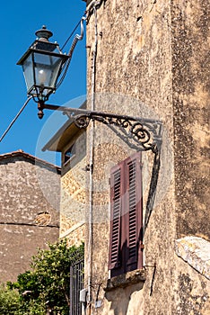 Old classical street lights at the facade of an old Italian house in Volterra