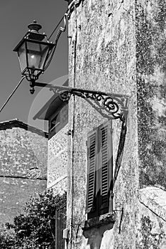 Old classical street lights at the facade of an old Italian house in Volterra