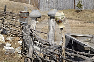 Old clay and cast-iron pots hanging on the fence. Old Slavic style. Ancient way of drying dishes