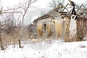 Old clay house in the Ukrainian village. Ruined clay house in the snow.