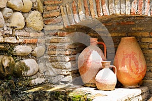 Old clay jugs in the brick and stone place