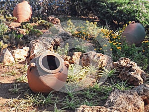 Old clay pots on the background of grass and stones